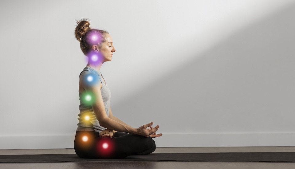 woman maintaining asana while chakra points are aligned